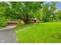 Beautiful single-story home with a detached garage on a sprawling lot with mature shade trees at 6794 E Ann St, Camby, IN 46113