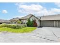 This home features an attached three-car garage, neat landscaping, and beautiful shrubbery on the front lawn at 7645 Briarstone Ln, Indianapolis, IN 46227