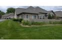 Well-maintained exterior with a lush green lawn and privacy fence offering curb appeal and tranquility at 7645 Briarstone Ln, Indianapolis, IN 46227