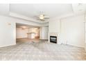 Spacious carpeted living room with a fireplace and views of the dining area and kitchen at 7645 Briarstone Ln, Indianapolis, IN 46227