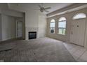Bright living room boasts a fireplace, large windows, and neutral carpet, creating a cozy atmosphere at 7645 Briarstone Ln, Indianapolis, IN 46227