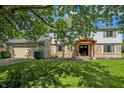 Charming two-story home with stone accents, mature trees, and a well-maintained lawn at 781 Dayton Dr, Carmel, IN 46033