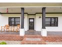 Warm and welcoming front porch with black accents, including a decorative wreath on the front door at 7895 E 175 N, Franklin, IN 46131