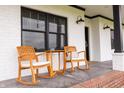 Close up view of the front porch with rocking chairs, showcasing the brick foundation at 7895 E 175 N, Franklin, IN 46131