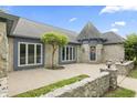 Elegant stone home featuring a unique turret entrance and well-maintained landscaping at 8029 Castle Lake Rd, Indianapolis, IN 46256