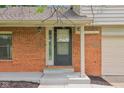 Inviting front entrance featuring a brick facade and a modern black front door at 9054 Cinnebar Dr, Indianapolis, IN 46268
