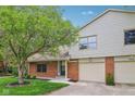 Charming home featuring a well-manicured lawn and attached two-car garage at 9054 Cinnebar Dr, Indianapolis, IN 46268