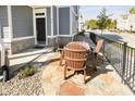 Relaxing front porch area featuring a charming outdoor dining set, perfect for enjoying the serene neighborhood views at 965 Astor Ln, Carmel, IN 46032
