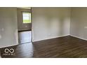 Neutral living room showcasing modern vinyl plank flooring, perfect for relaxation and entertaining at 1002 Brookside Ln, Plainfield, IN 46168