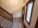 Entryway with carpeted stairs and a dark wooden door with a glass window at 1026 Summer Way Dr, Shelbyville, IN 46176