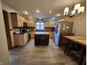 Bright, neutral kitchen featuring an island, stainless steel refrigerator, and breakfast table at 1026 Summer Way Dr, Shelbyville, IN 46176