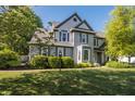 Charming two-story home with gray shutters and a well-manicured lawn, complemented by lush green trees at 107 W Columbine Ln, Westfield, IN 46074