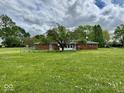 A lovely view of the backyard featuring an enclosed patio and fenced yard, offering a peaceful outdoor space at 1103 Canal St, Anderson, IN 46012