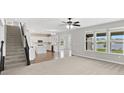 Open floor plan of the living room with adjacent kitchen, dining area, and staircase at 1276 Sanderling Dr, Greenwood, IN 46143