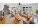 Inviting living room with plush seating, large windows and view into dining area and kitchen at 1276 Sanderling Dr, Greenwood, IN 46143