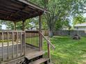 Cozy wood deck and fenced yard with mature trees offer outdoor relaxation and entertainment possibilities at 1280 Maple Ct, Martinsville, IN 46151