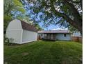 The backyard features a storage shed and a small wood deck on the back of the house at 1280 Maple Ct, Martinsville, IN 46151