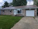 Charming brick home features a red roof, bay window, well-kept lawn, and an attached one car garage at 1280 Maple Ct, Martinsville, IN 46151