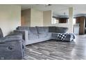Spacious living room with hardwood floors, a comfortable sectional sofa, and inviting natural light at 1461 Ripplewood Dr, Danville, IN 46122