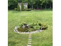 Expansive backyard featuring a serene pond with lush landscaping, complemented by a storage shed at 14814 Beacon Blvd, Carmel, IN 46032