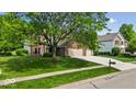 Charming home with a well-manicured lawn and a lovely tree-lined street at 14814 Beacon Blvd, Carmel, IN 46032