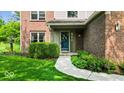 Charming front entrance with a well-kept garden and a welcoming pathway at 14814 Beacon Blvd, Carmel, IN 46032