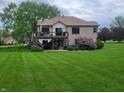 Expansive backyard with lush green grass and a spacious deck, perfect for outdoor entertaining at 1714 Michelle Mnr, Danville, IN 46122