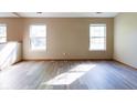 Spacious and bright living room with gray wood flooring and large windows at 18021 Sanibel Cir, Noblesville, IN 46062