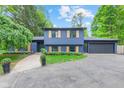 Eye-catching exterior of a blue house with charming wooden shutters and well-manicured landscaping at 1829 Kessler Blvd W Dr, Indianapolis, IN 46228