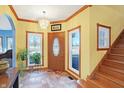 Welcoming foyer with tile floor, chandelier, wood trim and staircase at 186 W 600 N, Alexandria, IN 46001