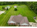 Aerial view outlining the property, showcasing the home, outbuildings, and green lawn at 2090 W County Road 400 S, Clayton, IN 46118