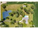 Bird's-eye view of home with a pond, pool, lush landscaping, and bordering farm fields at 3000 E County Road 400 N, Muncie, IN 47303
