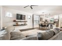 Bright living room featuring a modern sofa, ceiling fan, and an open view to the kitchen at 3047 N New Jersey St, Indianapolis, IN 46205