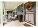Inviting front porch with comfortable seating, decorative rug, and stylish lighting at 3047 N New Jersey St, Indianapolis, IN 46205