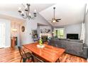 Open dining and living area with high ceilings, wood floors, and an elegant chandelier at 3348 Fox Orchard Cir, Indianapolis, IN 46214