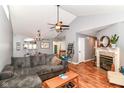 Cozy living room with high ceilings, wood floors, a fireplace, and a comfortable gray sectional at 3348 Fox Orchard Cir, Indianapolis, IN 46214