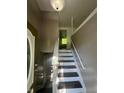 Bright entryway with newly painted walls and trim, leading to upper level and a clear view of the front door at 3541 Alpine Pl, Indianapolis, IN 46226