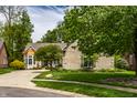 Lovely brick home with well-maintained landscaping and a large driveway at 3556 Towne Dr, Carmel, IN 46032