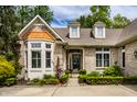 Charming front exterior featuring a bay window, brick facade, and manicured greenery at 3556 Towne Dr, Carmel, IN 46032