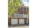 Brick townhome featuring a private balcony and a two-car garage, perfect for storage and convenience at 4024 Heyward Pl, Indianapolis, IN 46250