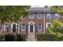 Charming brick townhome with classic blue shutters and meticulously maintained landscaping at 4024 Heyward Pl, Indianapolis, IN 46250