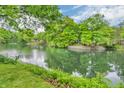 Picturesque lake view from a grassy lawn, framed by lush trees and waterfront features at 4154 W Briarwood Lake S Dr, Monrovia, IN 46157