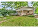Adorable cottage-style home with a covered porch, brick details, and lush greenery at 4154 W Briarwood Lake S Dr, Monrovia, IN 46157