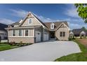 Charming home featuring a 3-car garage, brick and siding exterior, complemented by a well-manicured lawn at 4190 Hartswick Ct, Zionsville, IN 46077