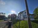 A charming white home with a street view and a patch of green grass at 421 N Canal St, Alexandria, IN 46001