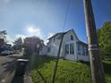 A charming white home with a street view and a patch of green grass at 421 N Canal St, Alexandria, IN 46001