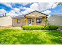 Charming bungalow featuring a lush lawn and inviting covered front porch at 433 N 15Th Ave, Beech Grove, IN 46107