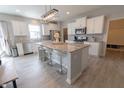Modern kitchen featuring a large island with seating, stainless steel appliances, and ample cabinet space at 4863 Sherlock Dr, Westfield, IN 46062