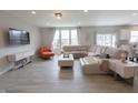Bright living room with a large sectional sofa, modern decor, and plenty of natural light at 4863 Sherlock Dr, Westfield, IN 46062