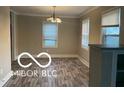Dining room with wood floors, neutral colors, and natural light from two windows creating a warm ambiance at 4943 S State Ave, Indianapolis, IN 46227